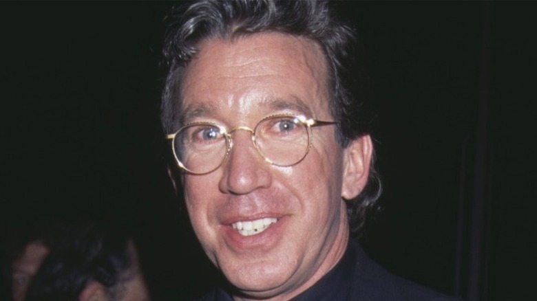 Tim Allen wearing glasses and smiling