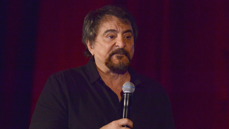 Tom Savini holds microphone