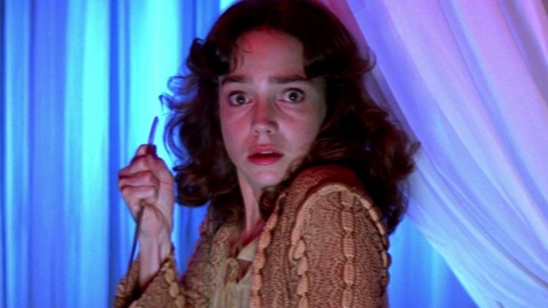 Suspiria girl holding a knife