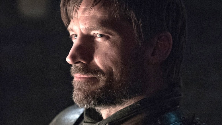 Jaime Lannister grinning and staring off screen