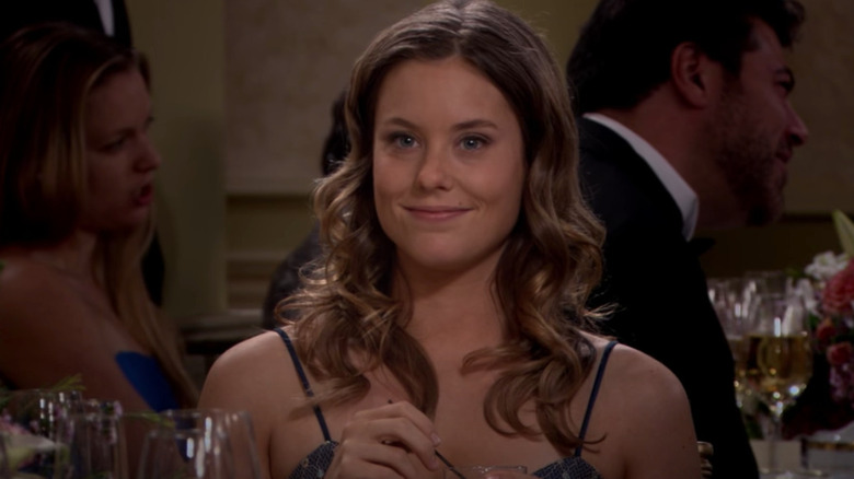 Victoria holds drink at wedding