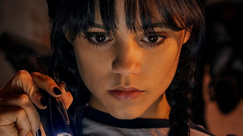 Jenna Ortega as Wednesday with flashlight