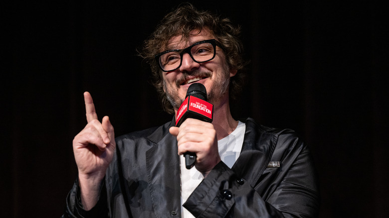 Pedro Pascal holding a microphone