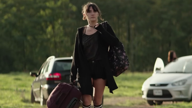 Izzy walking, looking serious arm raised