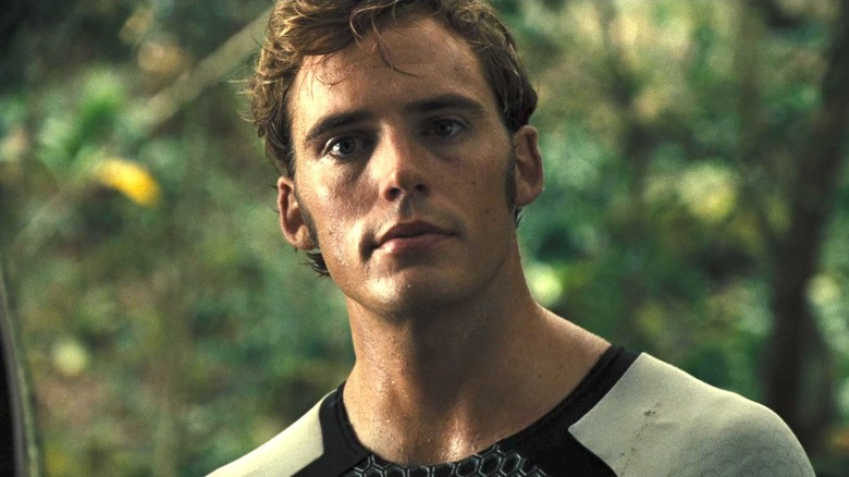 Finnick stands in jungle 