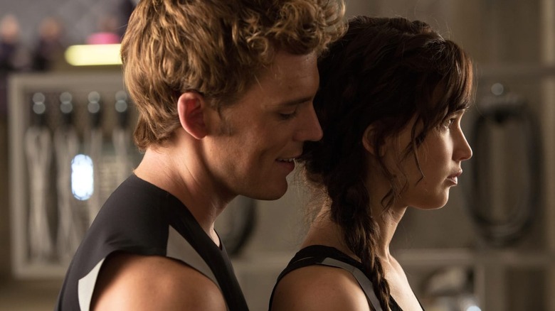 Finnick whispering into Katniss' ear