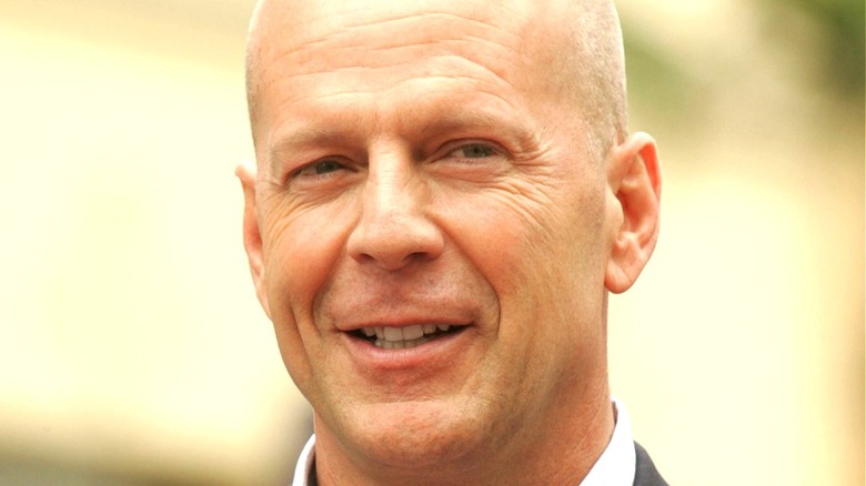 Bruce Willis smiling outdoors