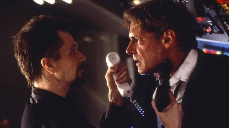 Korshunov hands President Marshall the phone in "Air Force One" (1997)