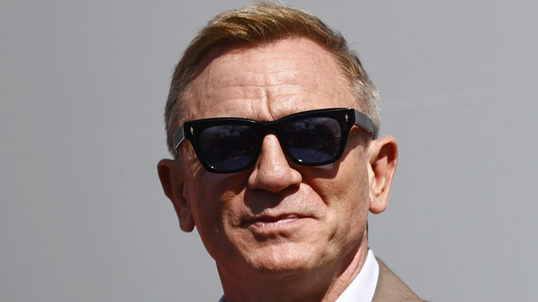 Daniel Craig smiling in sunglasses