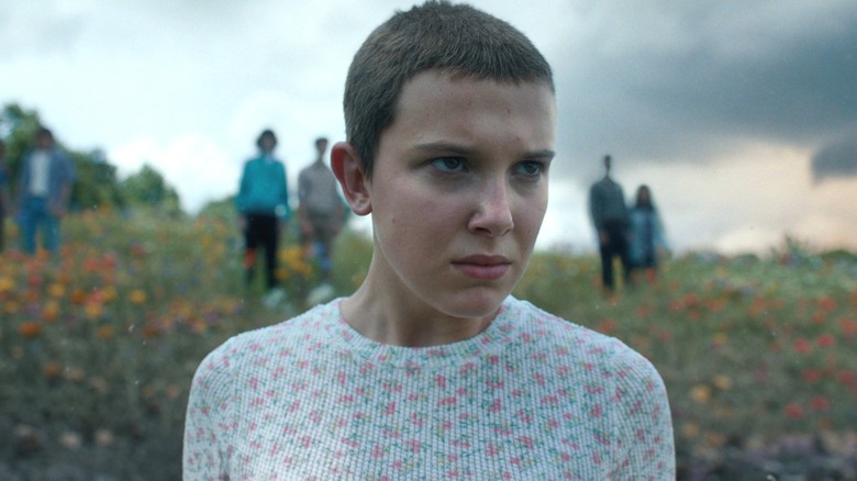Eleven standing in a field in 
