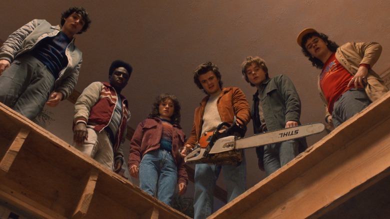The cast of "Stranger Things" looking into a hole