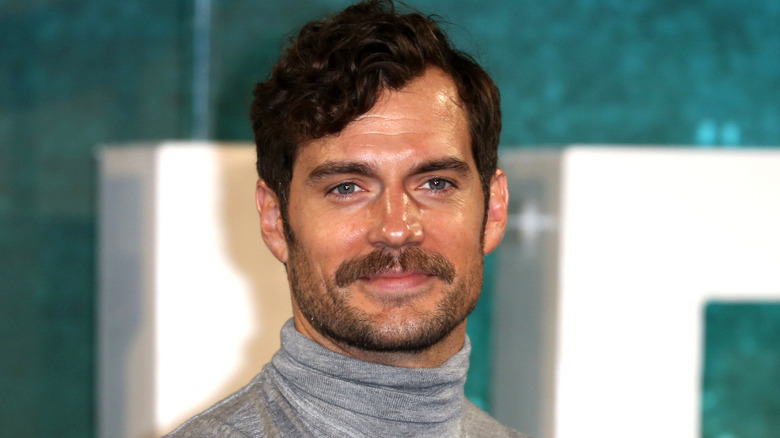 Henry Cavill smiling gray turtleneck