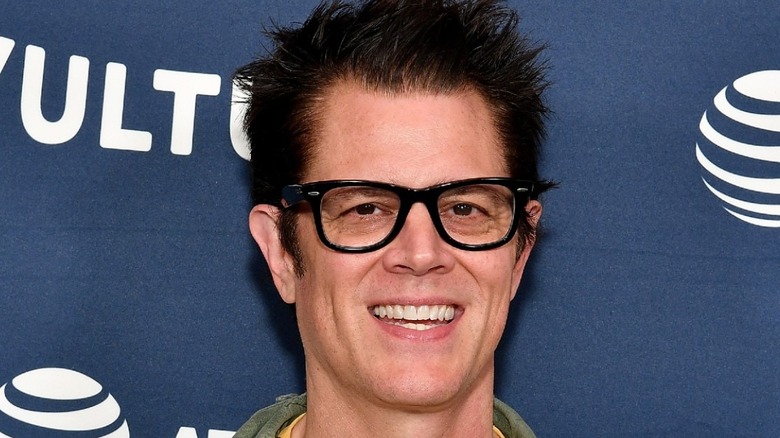 Johnny Knoxville wearing glasses and smiling