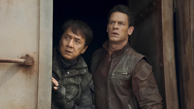 Chris Van Horne and Luo Feng peeking out of doorframe