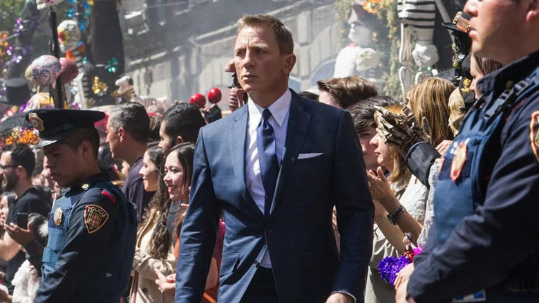 James Bond walking in the middle of a carnival in Spectre