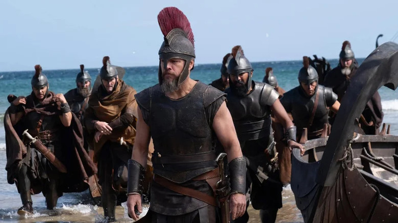 Odysseus and his men walking on the shore in The Odyssey