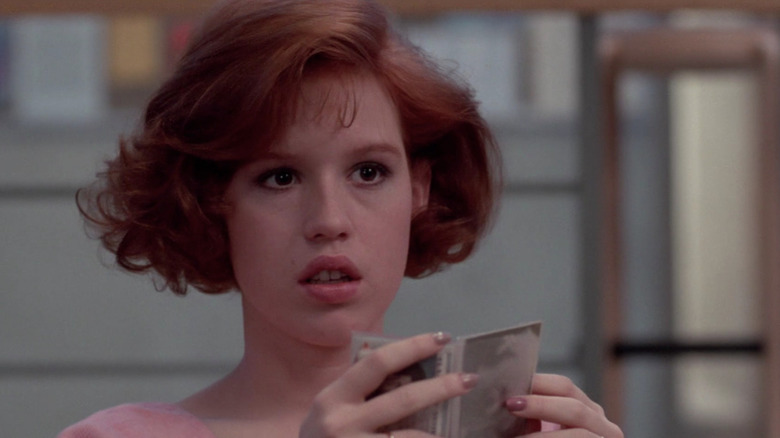 Claire talking and holding compact mirror