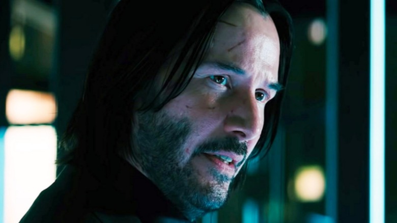 John Wick with cuts on his face