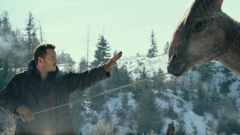 Owen Grady raising his hand to a dinosaur in Jurassic World Dominion