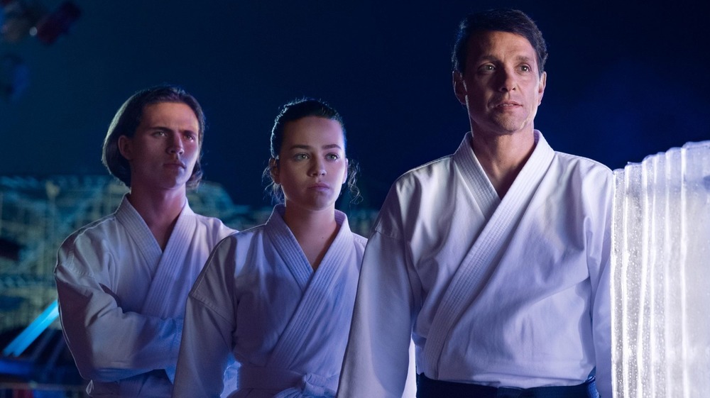 Ralph Macchio as Daniel LaRusso, Mary Mouser as Sam LaRusso, and Tanner Buchanan as Robby Keene on Cobra Kai
