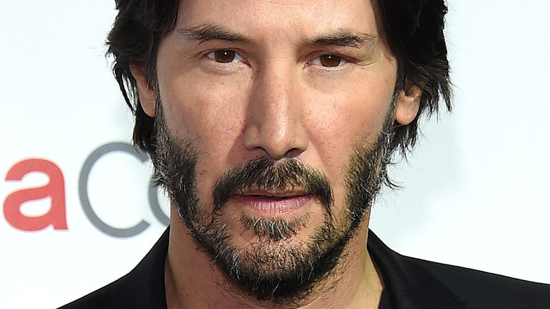 Keanu Reeves wearing a black shirt