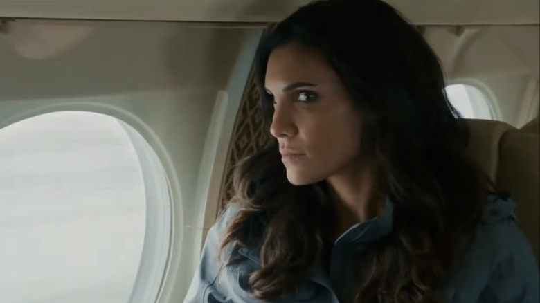 Kensi scowling at Deeks on a plane