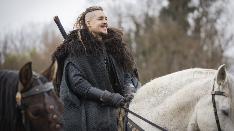 Uhtred smiling on horseback