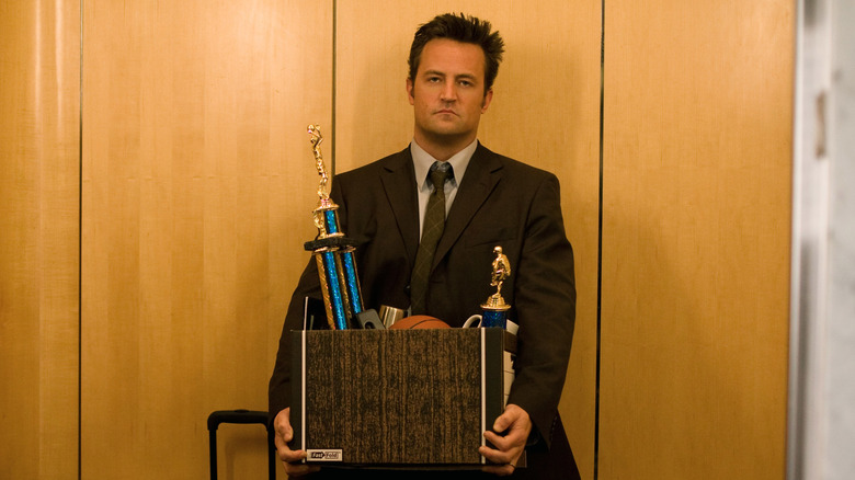 Mike with box of trophies in elevator