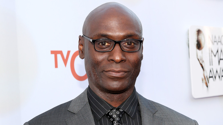 Lance Reddick at event smiling