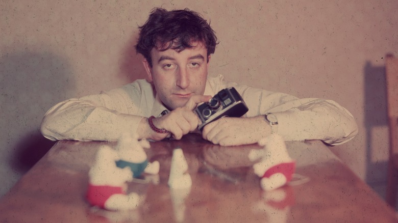 Peter Sellers holding a camera