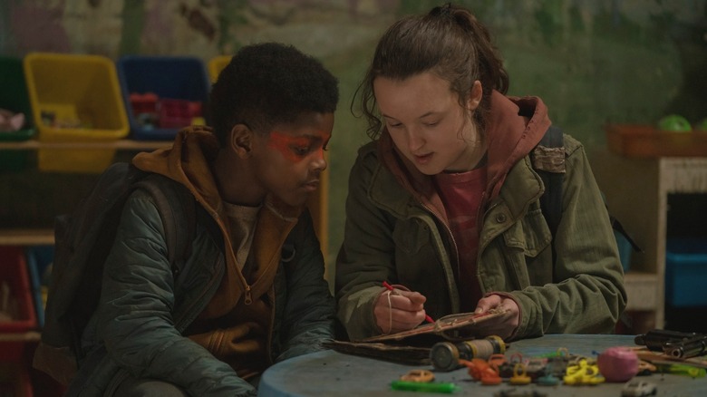 Keivonn Montreal Woodard and Bella Ramsey sitting at toy table