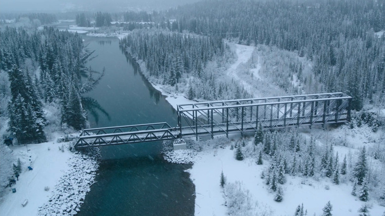 Overhead shot of snow-covered bridge and river