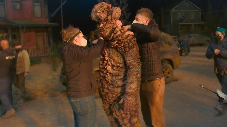 Adam Basil wearing a bloater costume on the set of The Last of Us