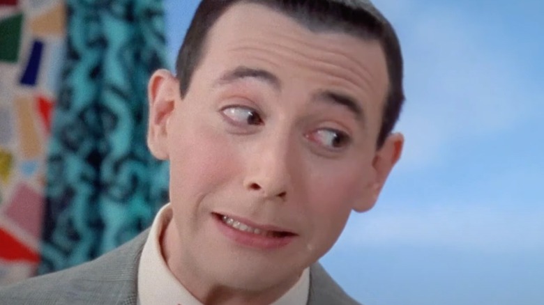 Paul Reubens as Pee-wee Herman leaning