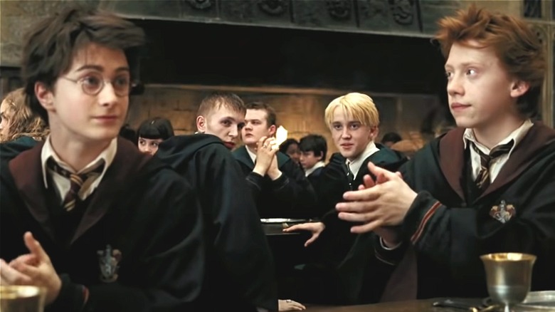 Harry, Malfoy, and Ron in dining hall 