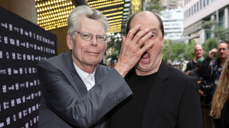 Stephen King covering Mike Flanagan's face