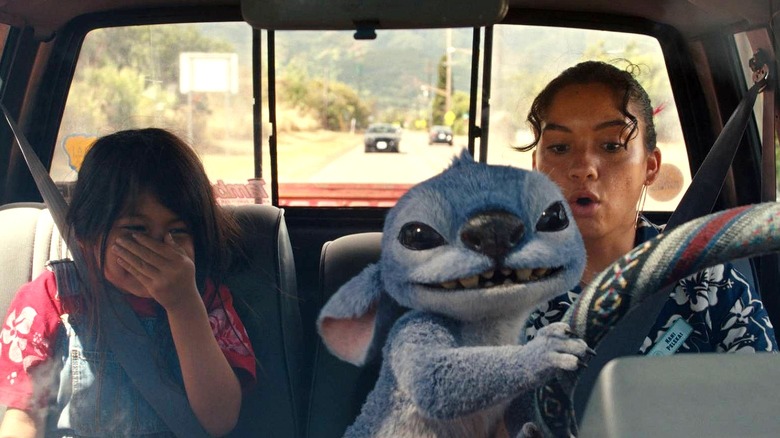Stitch driving a car with Lilo and Nani inside