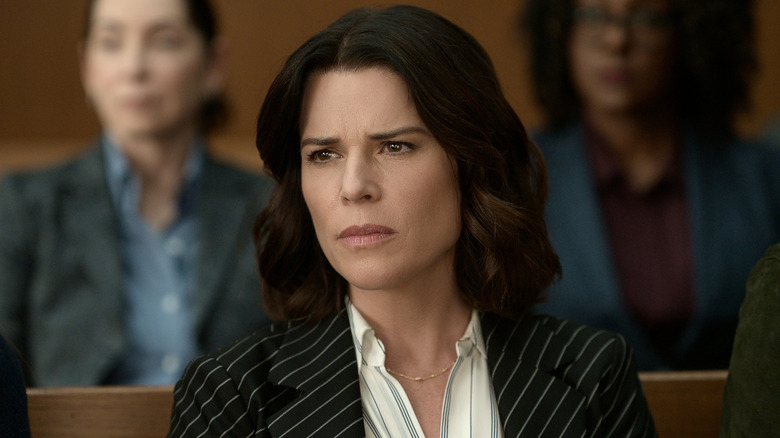 Maggie, in a pinstripe suit and staring, in "The Lincoln Lawyer"