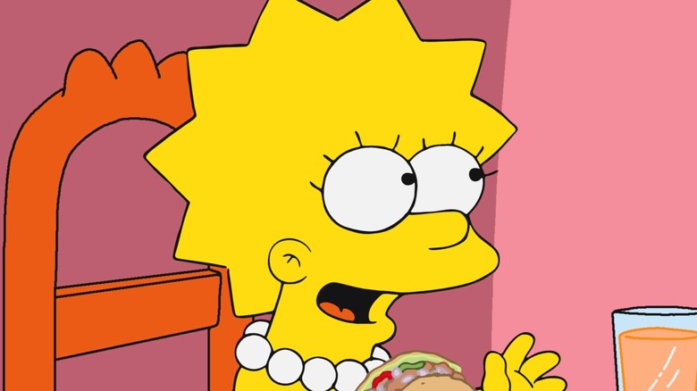 Lisa Simpson smiling at dinner table