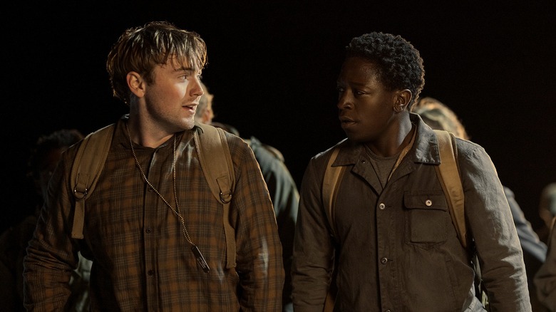 Garraty and McVries looking at each other while they walk at night (2025)