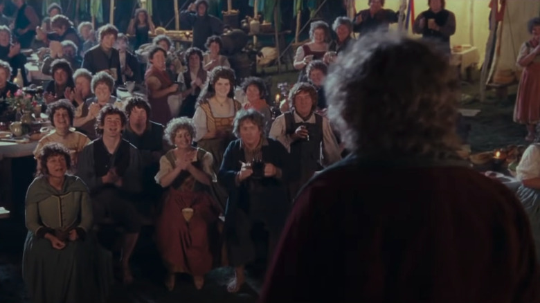 Bilbo in front of a crowd of Hobbits in "The Fellowship of the Ring"
