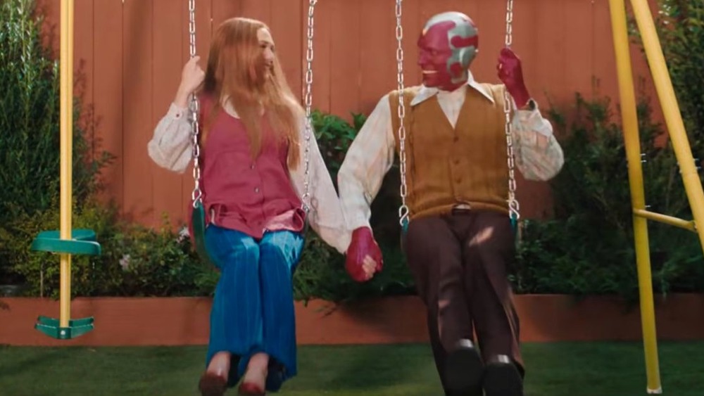 Wanda and Vision holding hands on swing