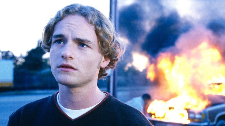 Francis looks away from a burning car