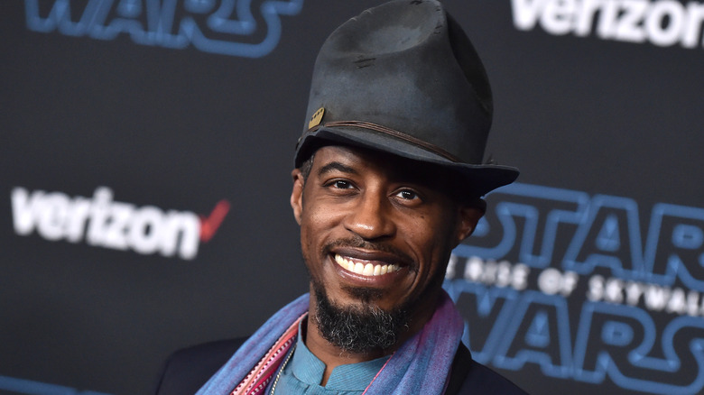 Ahmed Best smiling in front of a display for Star Wars: The Rise of Skywalker
