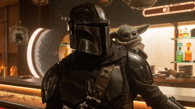 Din Djarin with Grogu on his shoulder in The Mandalorian and Grogu
