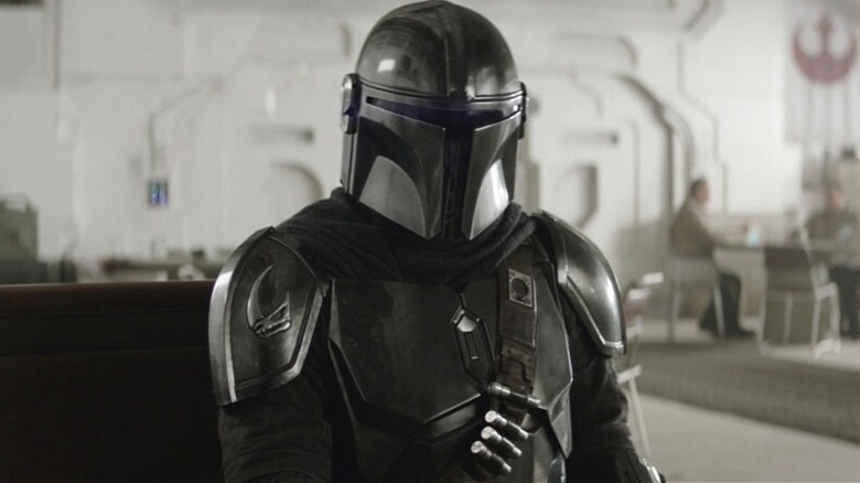 Din Djarin sitting in a diner in The Mandalorian and Grogu