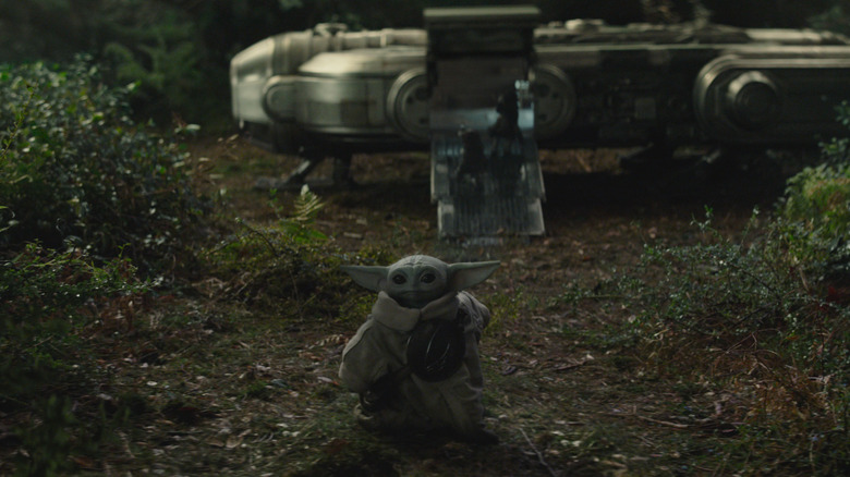 Grogu standing in front of a spaceship in The Mandalorian and Grogu