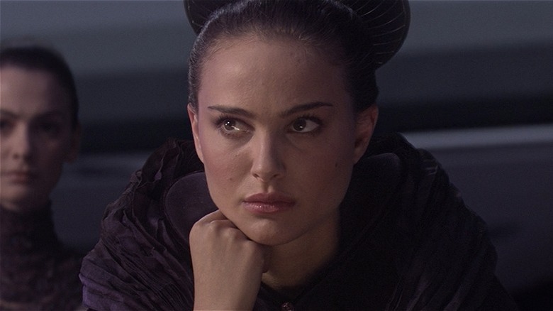 Padme leaning forward intently