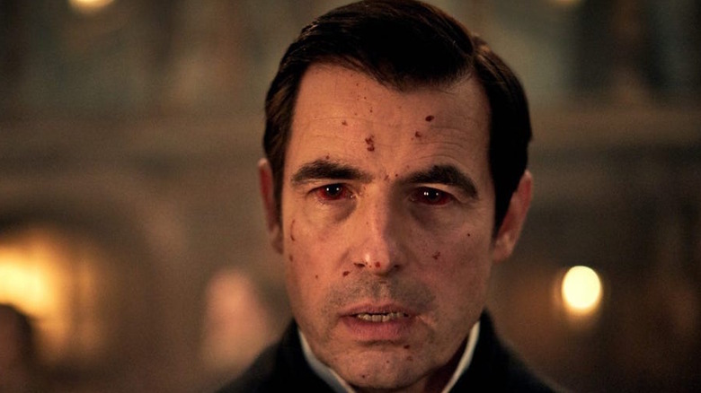 Claes Bang's face is bloody