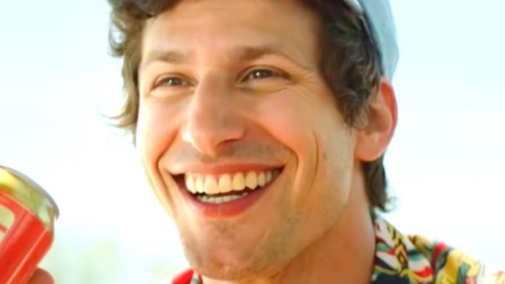 Andy Samberg with a giant grin